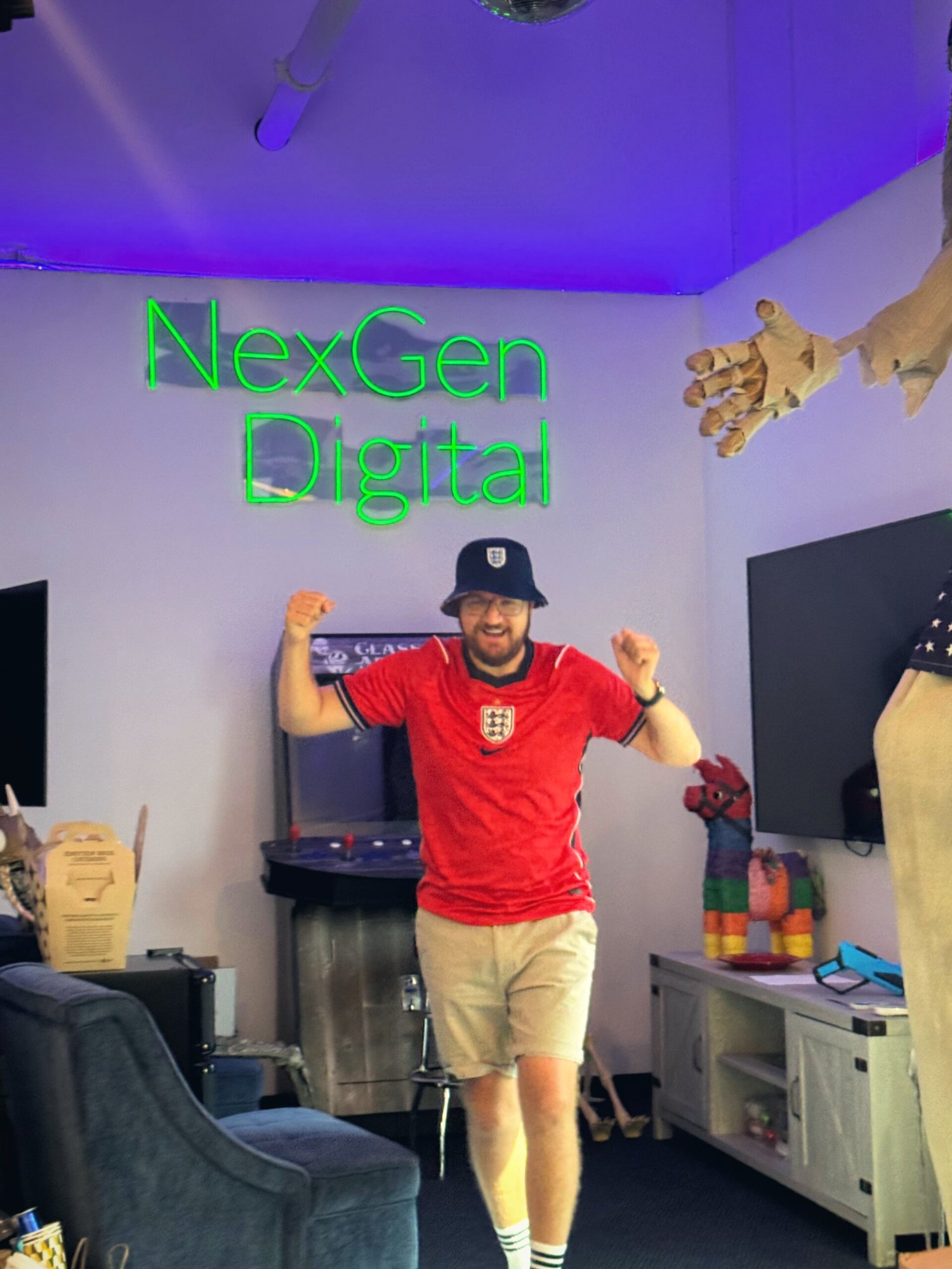 Mitchell Killingback in a full England kit and bucket hat in the Irvine break room.