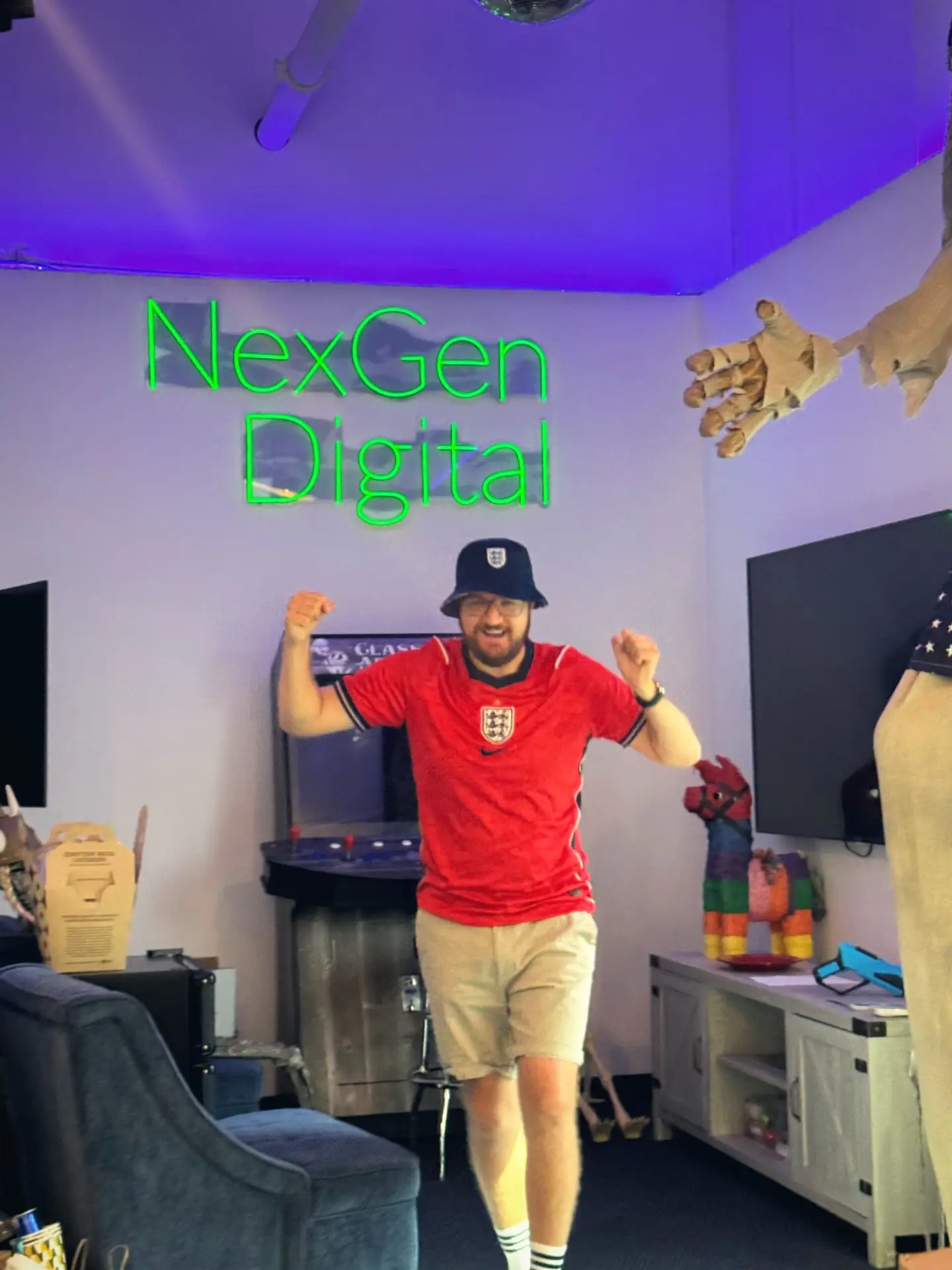 Mitchell Killingback in a full England kit and bucket hat in the Irvine break room.